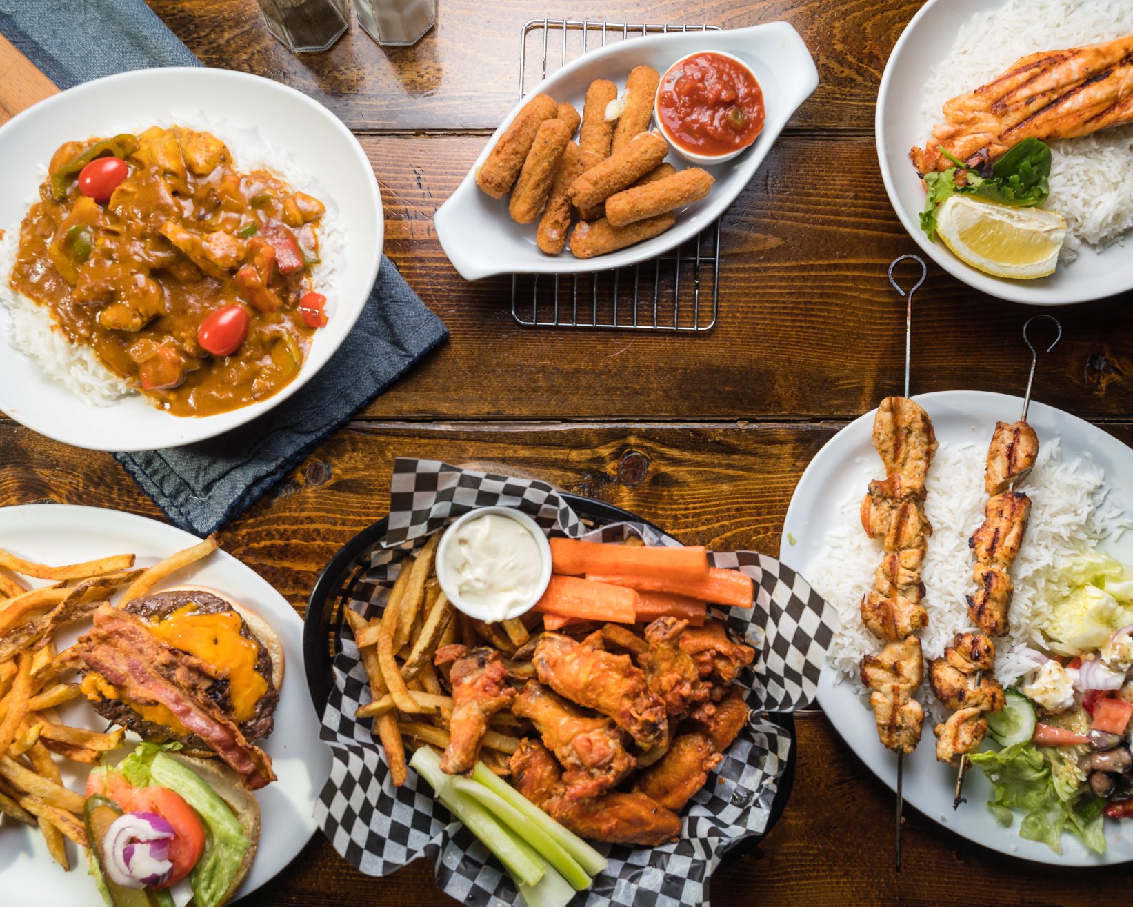 Spread of shareable pub favourites on a rustic table