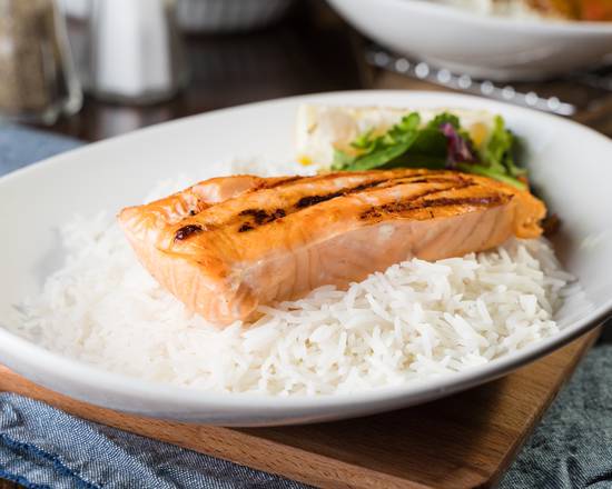 Seared salmon on rice with vibrant garnish